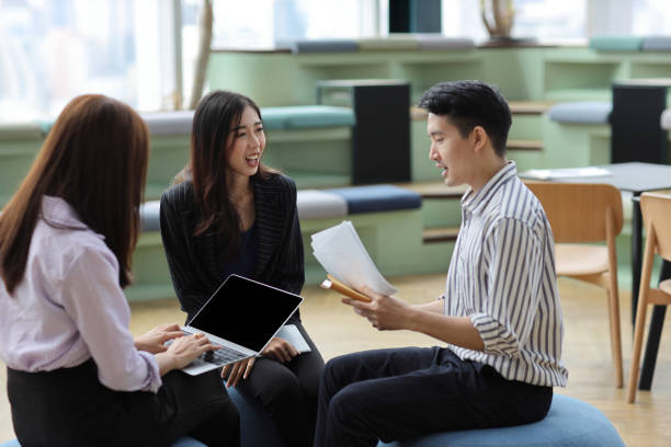 istock Collaborative process of young asian business people team working together discussing, researching, brainstorming and planning work at business meeting in modern office building and city background 1632887839