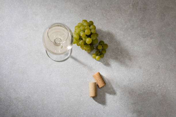 istock White wine in a glass and corks on the table. 1632909286