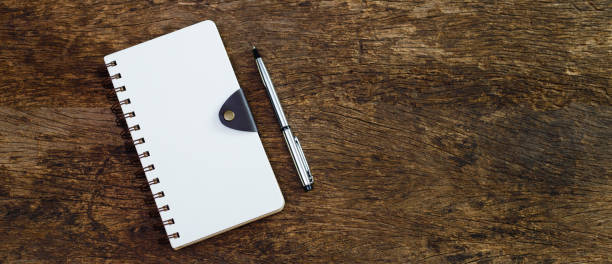 istock Notebook and pen on wooden background. write message diary book document education, Top view. 1632920058