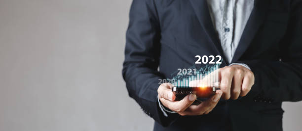 istock Businessman touching smartphone screen with growth graph year 2022. stock exchange analyzing chart. information statistics diagram profit global financial marketing. investment and marketing concept. 1632921630