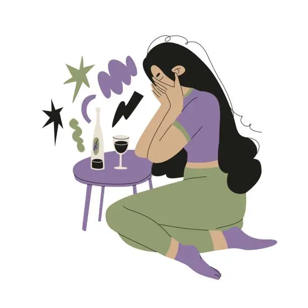Vector illustration of A woman with black long hair is crying on the flor, covering her face with her hands at a table with a bottle of wine and a glass. Female alcoholism, dependence and loneliness. Vector illustration.