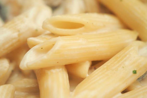 homemade cooked pasta in a plate on table .