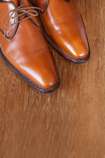 istock Brown leather shoes on a wooden floor 163297061