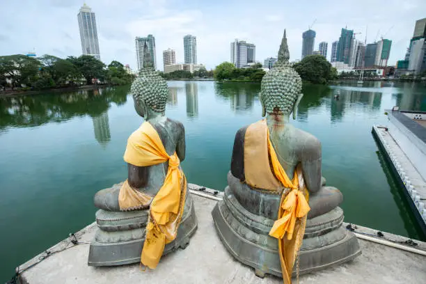 Photo of Bronze Buddha statues situated at Seema Malaka buddhist temple on Beira Lake in Colombo, Sri Lanka.