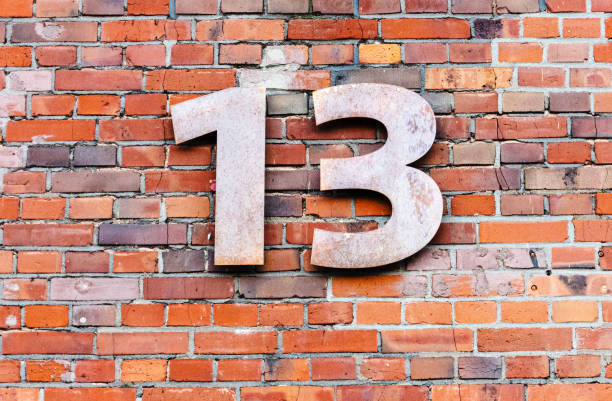 istock Metal number 13 on brick wall 1632984051