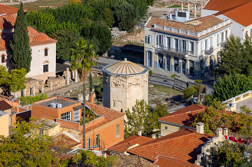 Athens, Greece - October 17, 2022: Aerial view of city with  Tower of the Winds, octagonal marble tower in the Roman Agora