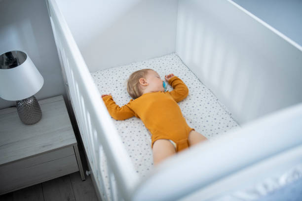 istock Baby boy laying in his crib asleep. 1632987272