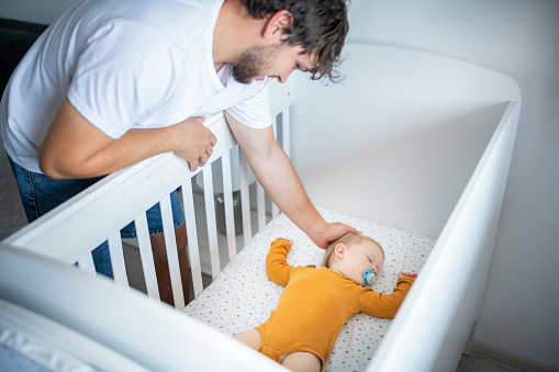 a newborn sleeps in a white crib. the concept of healthy children's sleep.