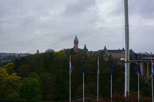 City Bank of Luxembourg, resembling a medieval castle, emerges gracefully under cloudy skies. Its historical aura merges with modern finance.