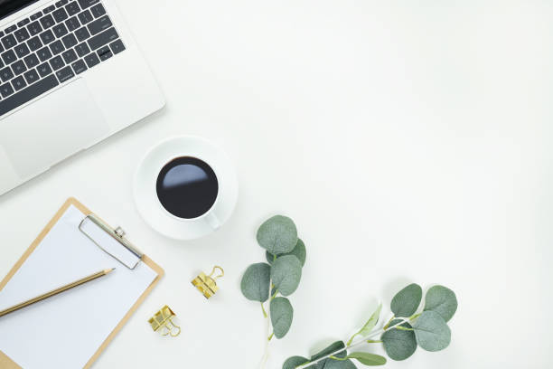 istock Top view office table desk workspace frame with green leaves eucalyptus, clipboard and coffee cup isolated on white background. Flay lay,  ideas, notes or plan writing concept 1632994261