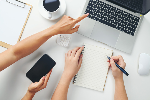 Teamwork with laptop, notebook, hand, smartphone or cellphone on white background. Solution, business people, financial analysis, accounting, start up or working flat lay top view concept.