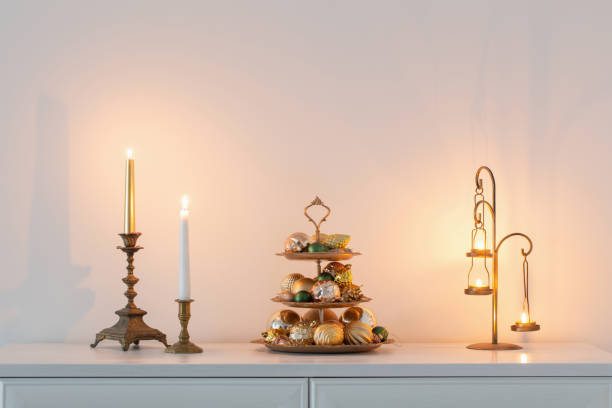 istock christmas golden decor with burning candles in white interior 1633025626