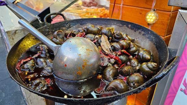 istock Stir fried shellfish with sauce in tradition seafood market 1633038485
