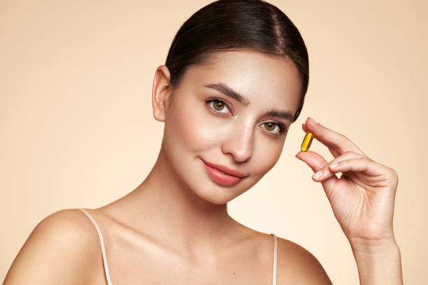 istock Beautiful Girl With Pill With Cod Liver Oil Omega-3 1633051835