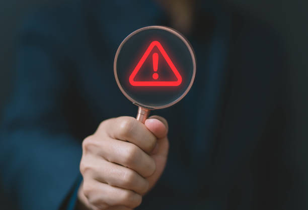 istock red warning sign show in magnifying glass 1633064993