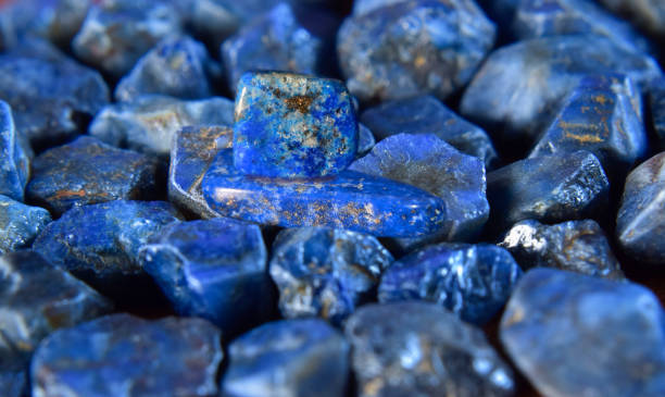istock Lapis Is a beautiful natural gemstone on a wooden floor 1633072766