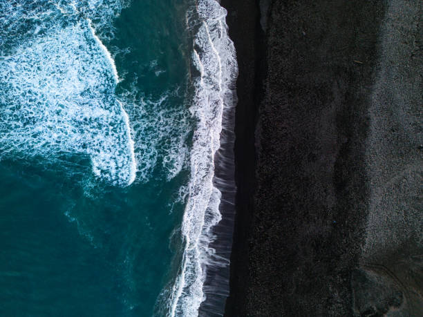 istock Drone shot of natural black sand beach 1633073031