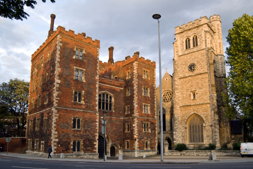 Lambeth Palace, a historical landmark, the London seat of the Archbishop of Canterbury, the head of the Anclican Church since mediaval times. To the right is the the deconsecrated parish church of St Mary-at-Lambeth, now housing the Museum of Garden History. London, UK.