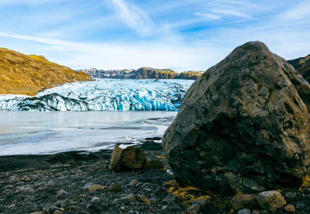 Big vatnajokull glacier cap in iceland next to frozen water in polar landscape, massive diamond shaped ice blocks in cold winter nature. Scandinavian arctic iceberg lagoon and icy rocks.