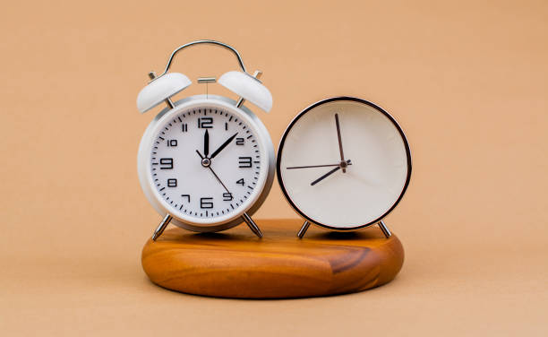 istock Modern alarm clock placed on a wooden plan Time clock, notifications, alarms time and work concept 1633084772