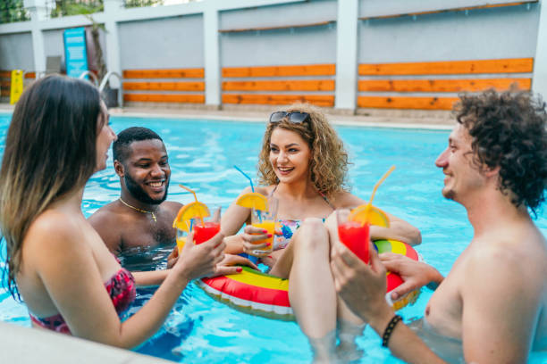 istock Friends enjoying in the swimming pool 1633142462