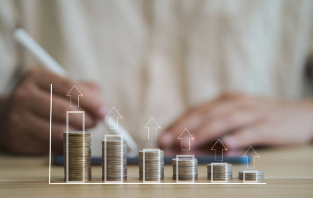 istock Businessman checking account There is a vertical stack of coins with a rising graph. Greater income concept Arrange the coins in a growing graph. 1633150158