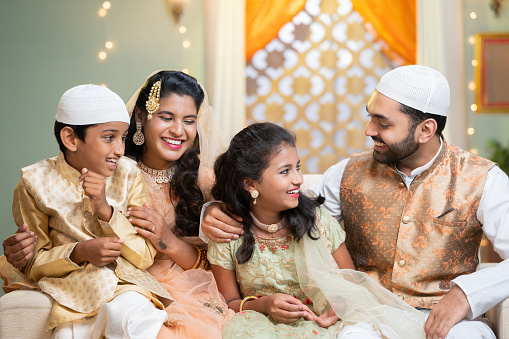 closeup shot of indian muslim family celebrating or enjoying ramadan festival with kids at home