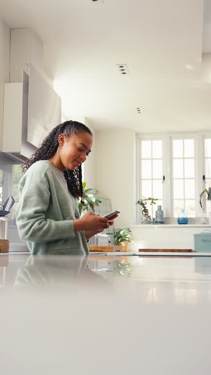 Vertical Video Of Teenage Girl At Home Connecting With Friends On Social Media Using Mobile Phone