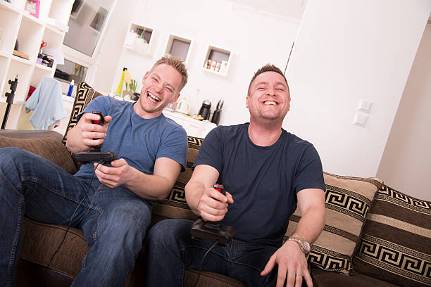 istock Two guys laughing over video games 163316905