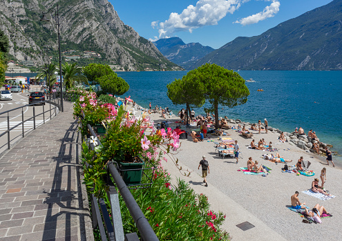 Sunny beach scenery at Limone sul Garda, a town and comune located at the Lake Garda in Northern Italy