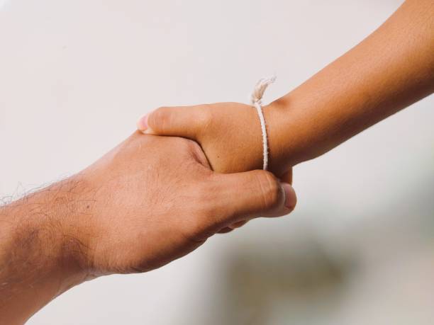istock Handshake between an adult and a girl 1633187475