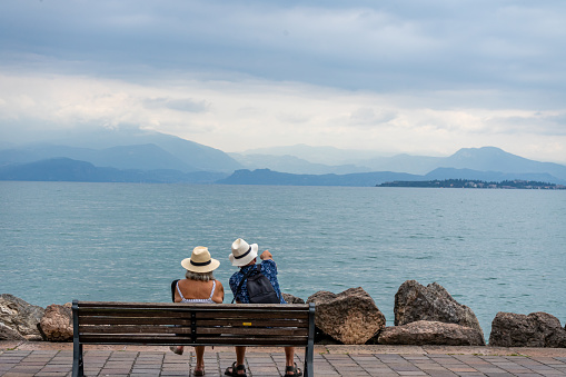 old couple on the pier at the lake Garda