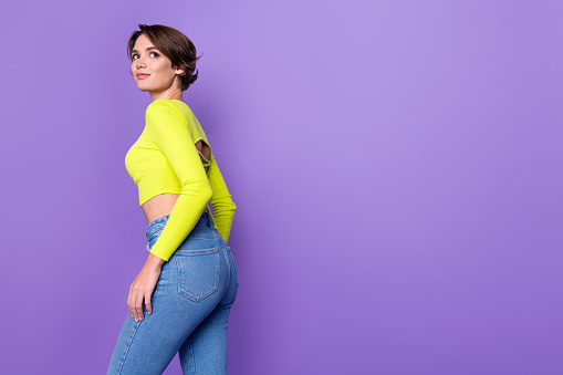Profile photo of stunning positive lady posing look empty space advertisement wear lime top isolated on violet color background.