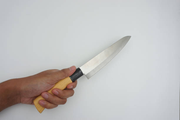istock hand brandishes a knife 1633233686