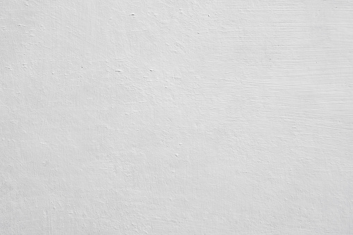 Grained surface of primed cardboard with white acrylic paint for oil painting. Fragment of a white wall as a background for posters and banners