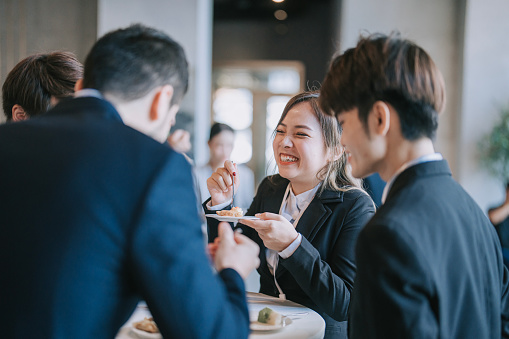 Asian Chinese businesswoman laughing enjoying coffee break during business conference seminar