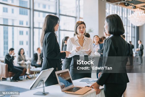 istock Asian business women at seminar business conference registration counter in the morning 1633285112