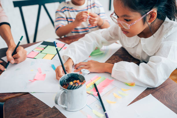 istock Happy school teacher and students having interesting engaging activities in class. 1633289586