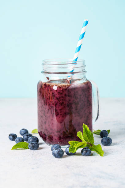 istock Blueberry smoothie with fresh berries at blue background. 1633312216