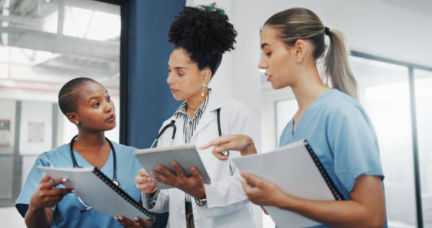 istock Doctors, nurses or women on tablet, documents or paper in diversity meeting, help collaboration or hospital teamwork. Talking, healthcare or workers on technology, surgery research or life insurance 1633320191
