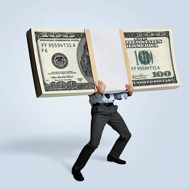 Money Businessman holding big bundle of money huge pile of money stock pictures, royalty-free photos & images