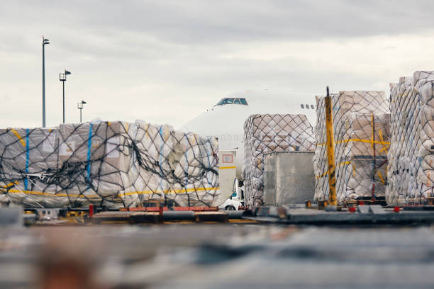 istock Loading of cargo containers to plane at airport 1633329878