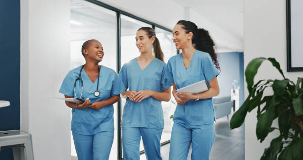istock Talking nurses, walking and documents in hospital teamwork, diversity collaboration or bonding on surgery or clinic break. Smile, happy and healthcare women with medical research, paper or funny joke 1633330985