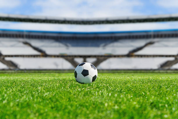 ball on the green field in soccer stadium. ready for game in the midfield ball on the green field in soccer stadium. ready for game in the midfield stadium playing field grass fifa world cup stock pictures, royalty-free photos & images