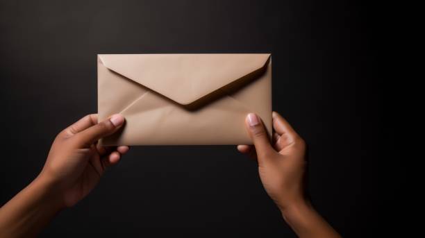 istock African-American woman's brown-skinned hands, holding a voting envelope or letter envelope 1633362926
