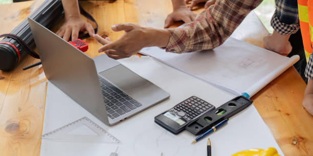 istock architects or engineers write a draft of the construction project on the blueprint. 1633378447