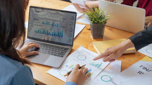 istock accountant with laptop and paperwork analyzing financial data report 1633378982