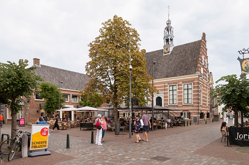 IJsselstein, Netherlands, August 19, 2023; Cozy square with the historic town hall in the background in the town of IJsselstein.