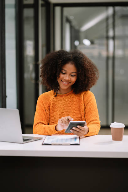 istock Women are using calculators to calculate office income. 1633429889