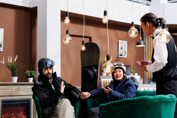 istock Employee assists couple for ski activity 1633453680
